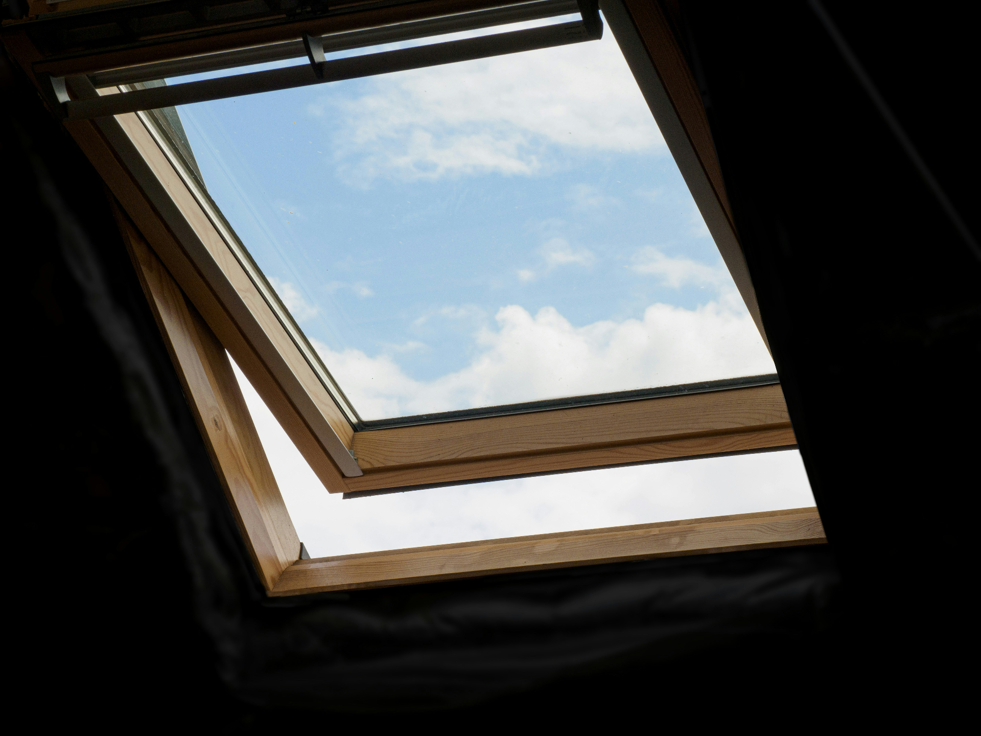 Skylight installed in a Florida home looking up at a blue sky