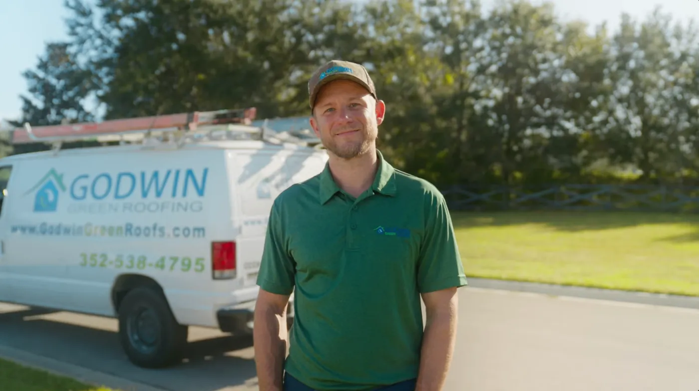 Christopher Tenney standing in front of a Godwin Green Roofing work truck in Gainesville